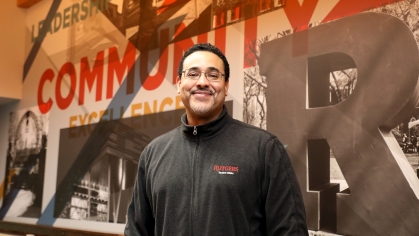 Dr. Mena in front of mural